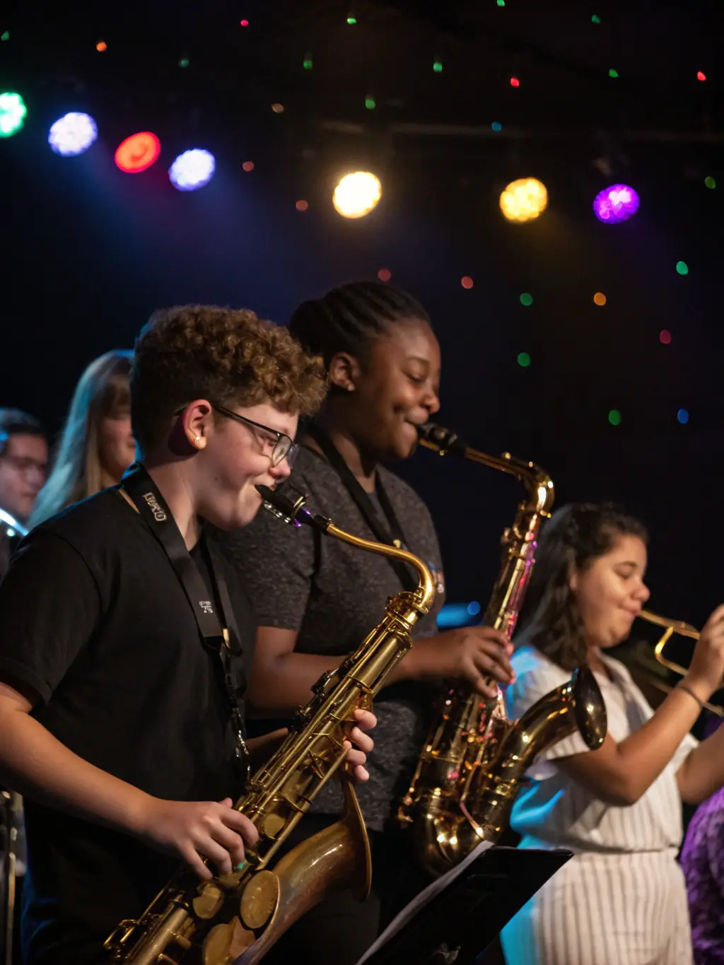 A dynamic image of the saxophone quartet collaborating with other musicians during a collaborative concert, showcasing diverse musical styles.